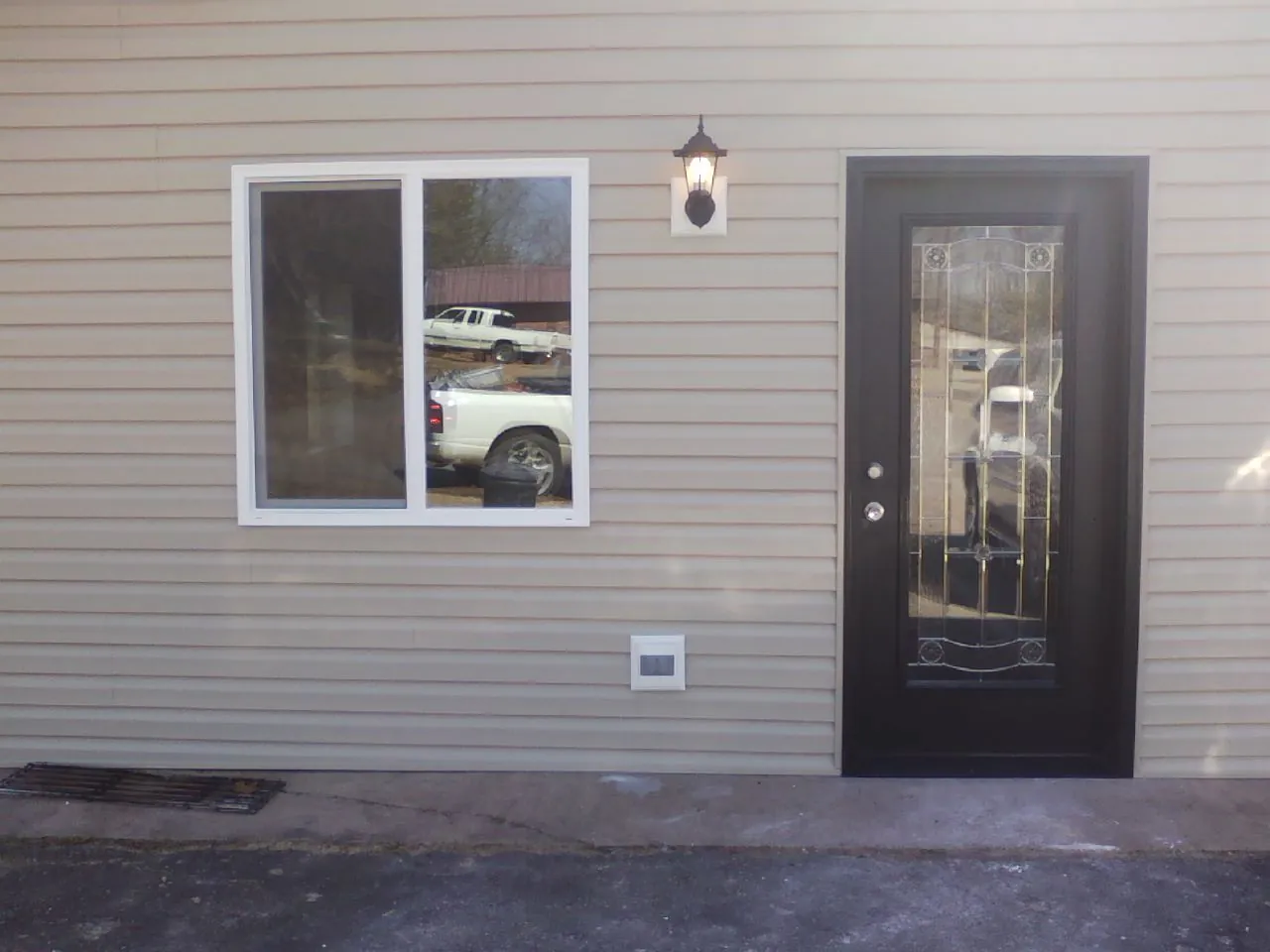 New siding, window and entry door on the side of an addition in Lenhartsville