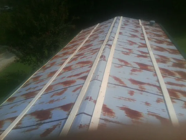 Rusted metal roof panels with new wood purlins before replacement — Storm Damage Roof Repair in Lenhartsville by Roofing Brothers