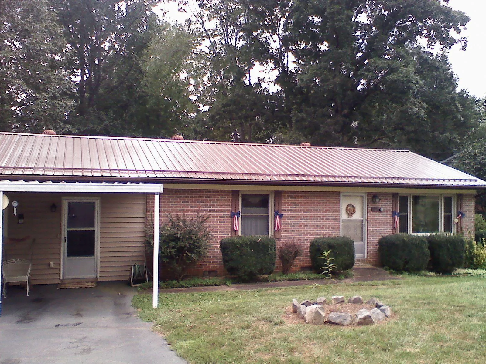 Bronze metal roof and carport on a brick ranch home — Roof Repair work by our crew in Lenhartsville