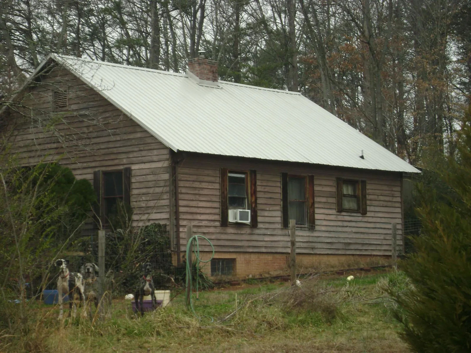 White metal roof on an old wood sided farmhouse, from a Metal Roof Installation job in Lenhartsville